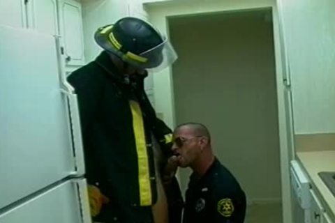 pretty Fireman And Police Officer poke On The couch