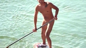 A CHINESE MUSCLE BEAR PLAYING SUP in nature's garb